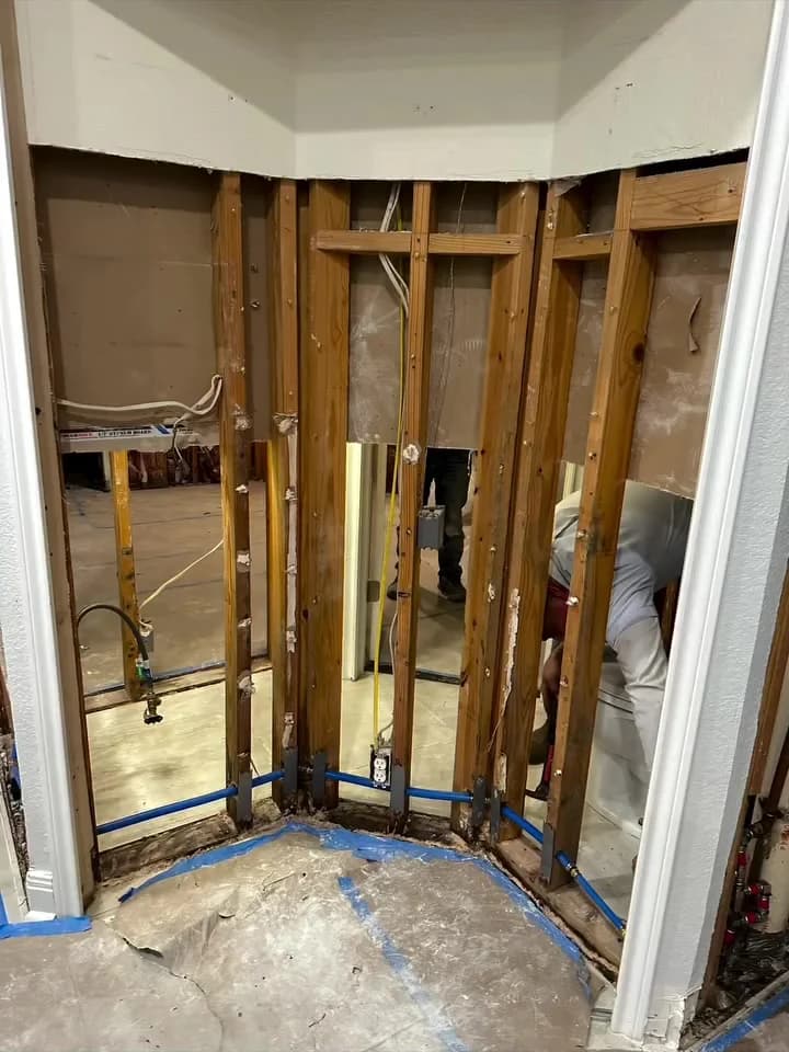 Original New Life restoration project with a damaged wall opened to the framing before drywall rebuilding