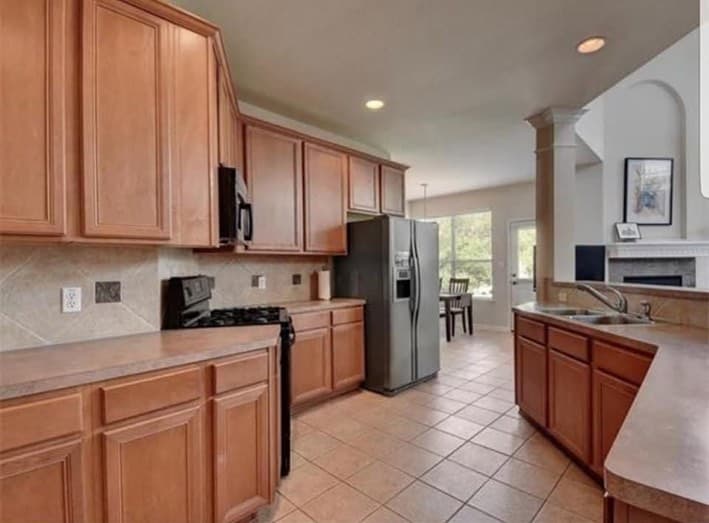 Traditional wood kitchen cabinetry before a painted finish update