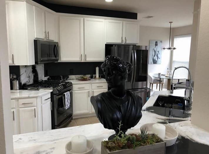 The same kitchen cabinetry after a bright white painted finish