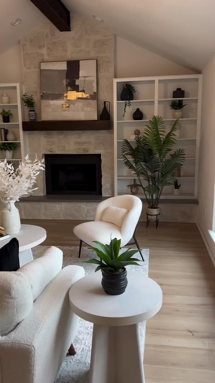 Finished New Life living room with a refreshed fireplace, white built-ins, and new flooring