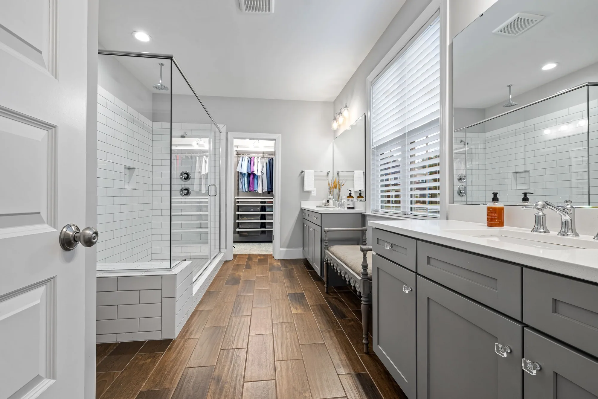 Bright bathroom design inspiration with two vanities and a glass walk-in shower