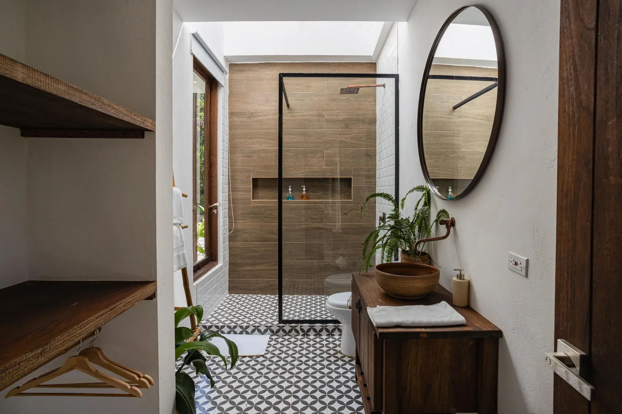 Warm bathroom design inspiration with wood-look shower tile, patterned flooring, and a wood vanity