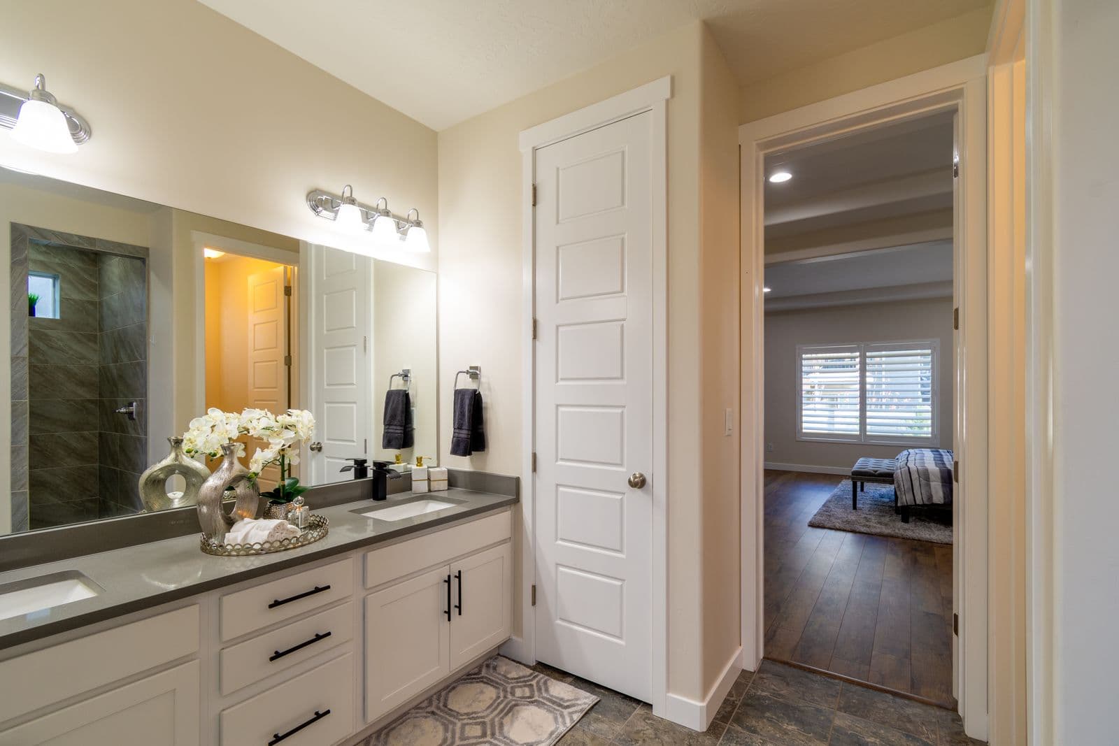 Bright bathroom design inspiration with a white vanity, large mirror, and organized storage
