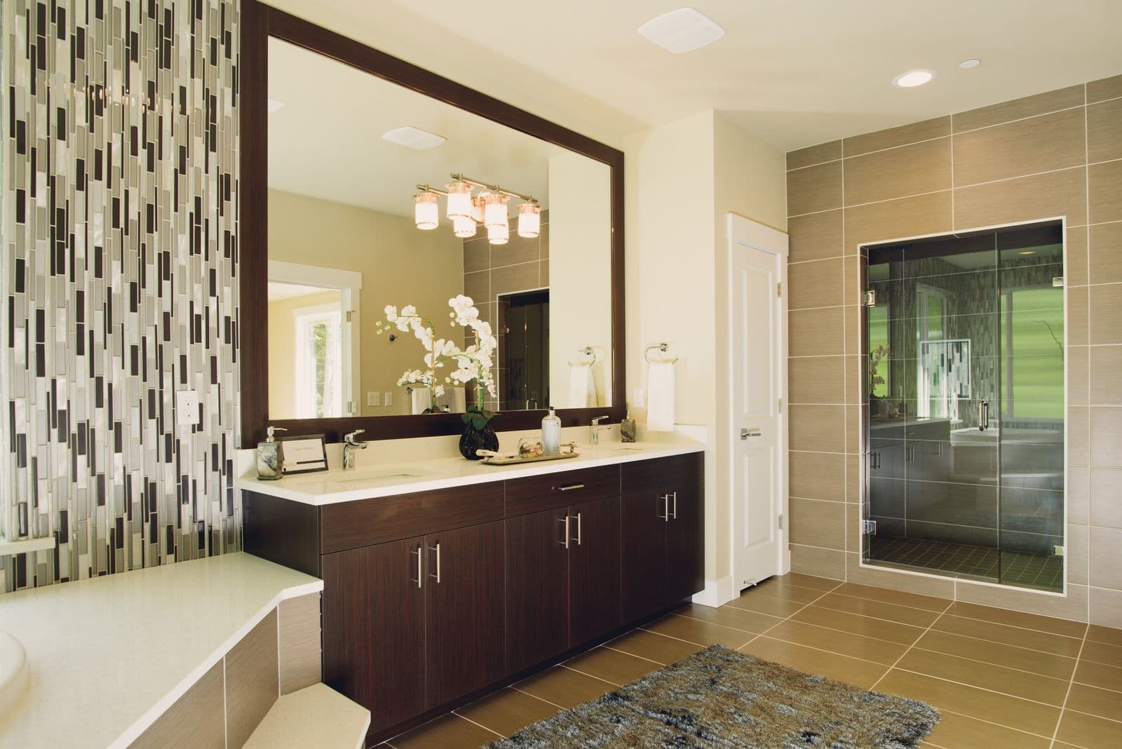 Modern bathroom design inspiration with a glass shower, floating vanity, and warm neutral finishes