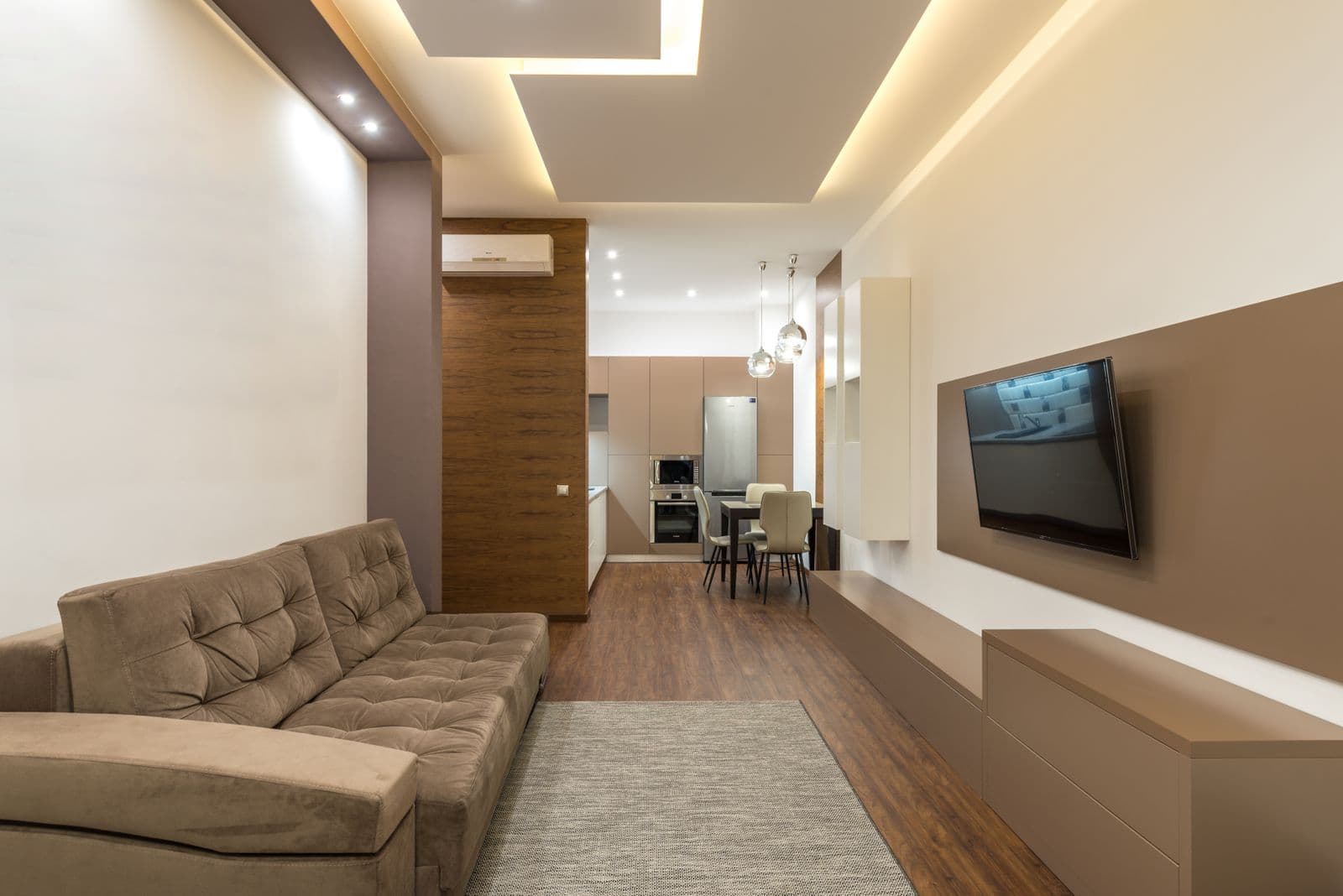 Modern open-plan Austin home design inspiration with continuous wood-look flooring