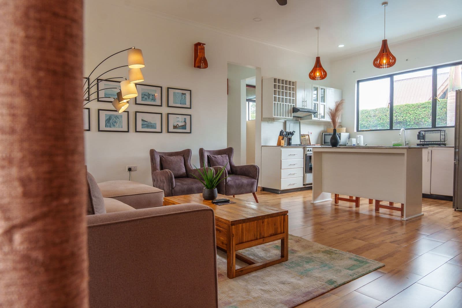 Warm open-plan living room and kitchen with continuous wood flooring