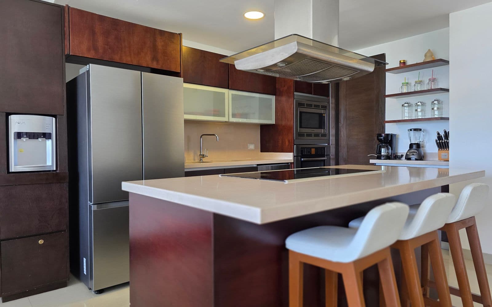 Modern kitchen design inspiration with dark wood cabinetry, stainless appliances, and a large island