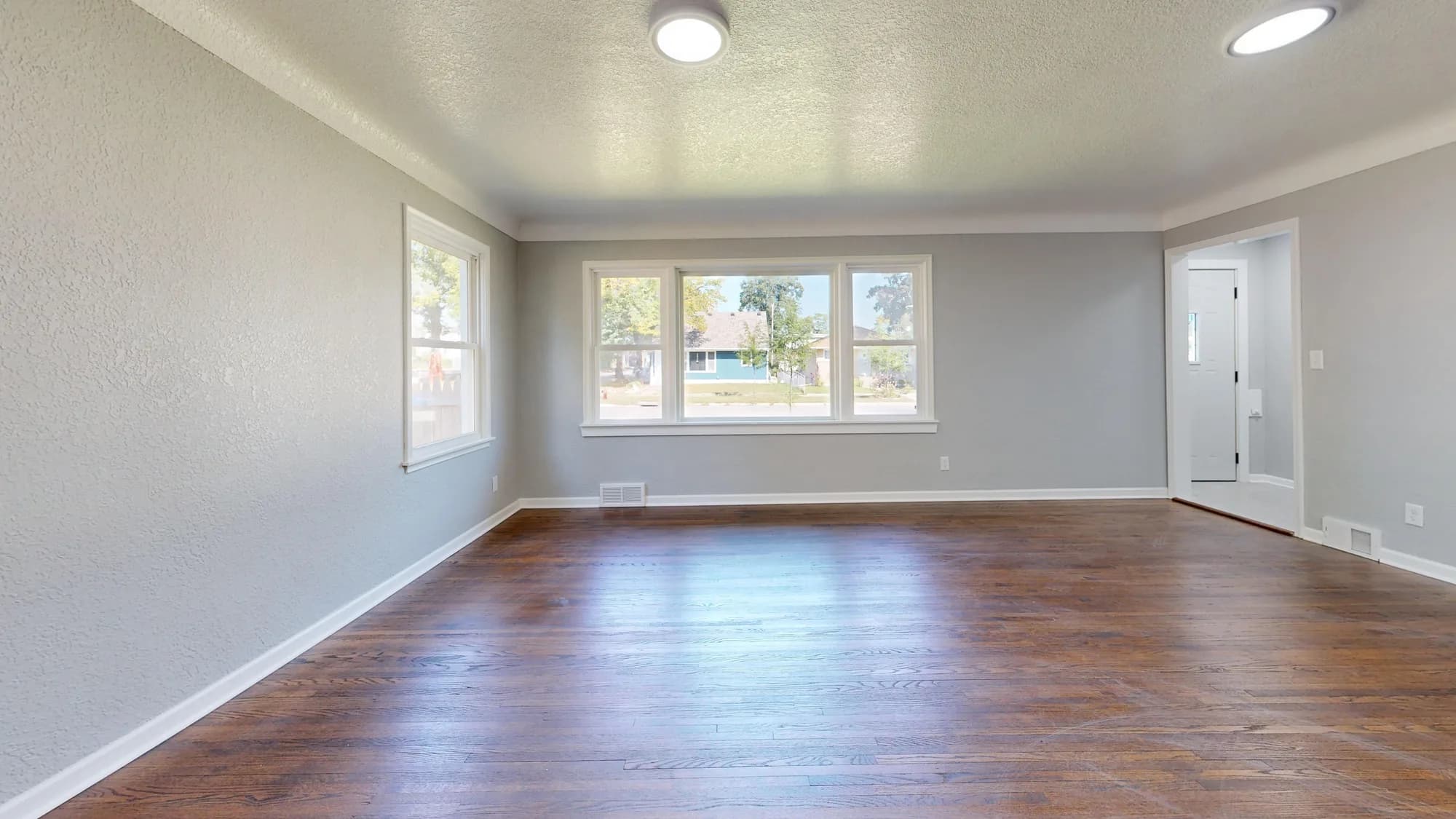 Sunlit room with hardwood flooring shown as design inspiration