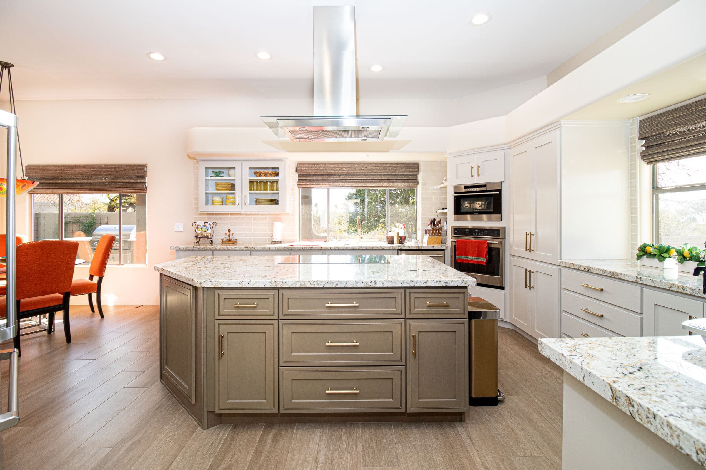 Bright modern kitchen with a large island, cabinetry, and stone countertops