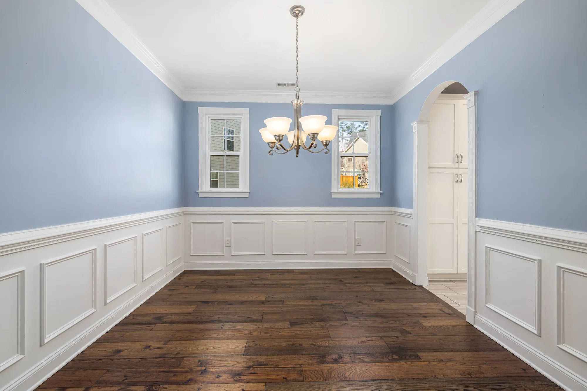 Dining room trim inspiration with crown molding, window casing, chair rail, and picture-frame wall molding