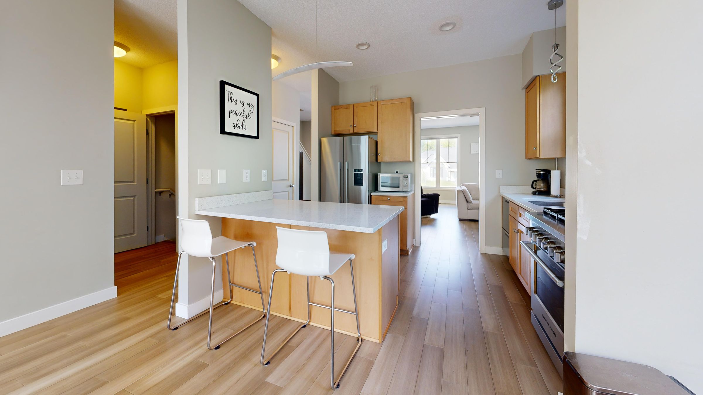 Warm open-plan kitchen design inspiration with wood cabinets, island seating, and a dining area